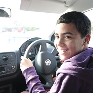 A Young Driver behind the wheel of the car