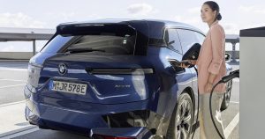 Woman charging her electric car
