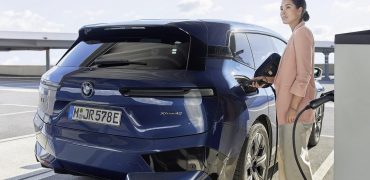 Woman charging her electric car