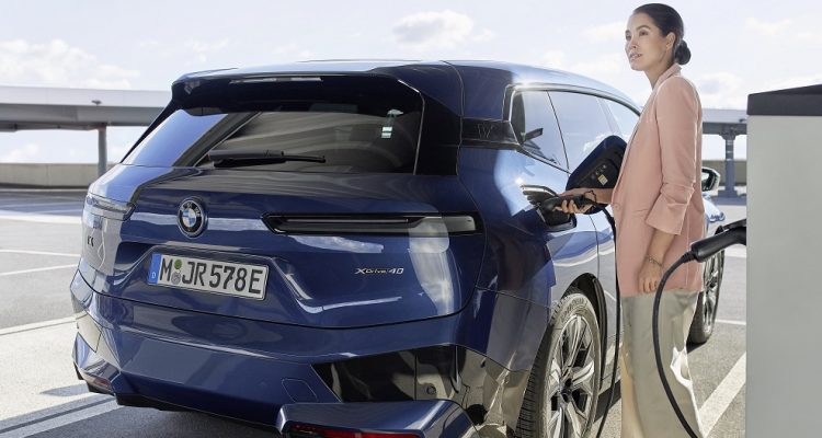 Woman charging her electric car
