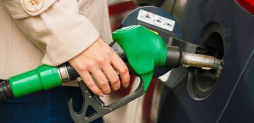 Woman Fueling A Car