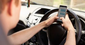 Driver texting on mobile phone