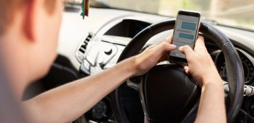 Driver texting on mobile phone