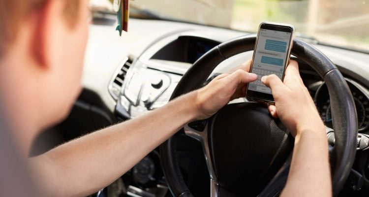 Driver texting on mobile phone