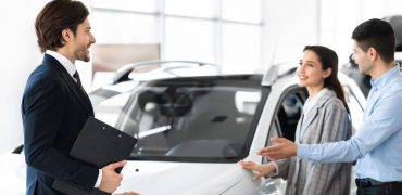 Man and woman purchasing a car