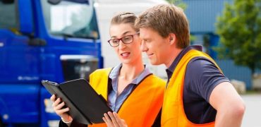 HGVC trainee and Instructor looking at an app