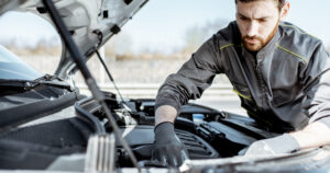 Mobile mechanic working on an engine