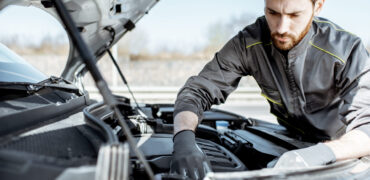 Mobile mechanic working on an engine
