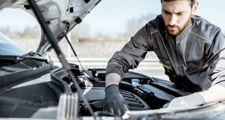 Mobile mechanic working on an engine