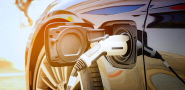 Electric car being charged in the sunshine