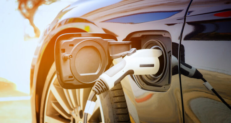 Electric car being charged in the sunshine