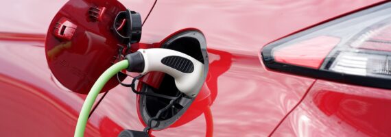 Red electric car being charged