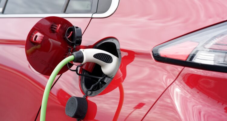 Red electric car being charged