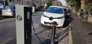 White electric car using a public charging point