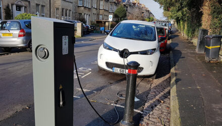 White electric car using a public charging point