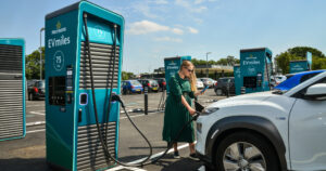 Lady charging her car at a GeniePoint charger in Clacton