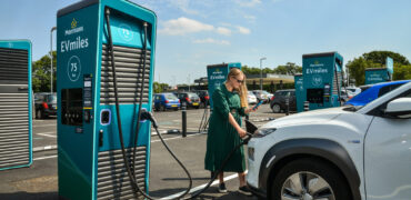 Lady charging her car at a GeniePoint charger in Clacton