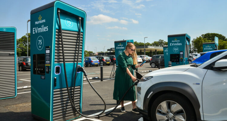 Lady charging her car at a GeniePoint charger in Clacton