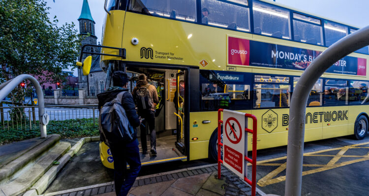 Passengers board one of the first of Manchester's franchised bus services