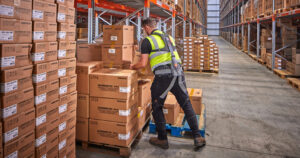 Worker wearing Hunic Exoskeleton lifting boxes