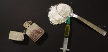 Image of a syringe and drugs