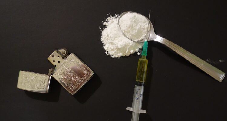 Image of a syringe and drugs