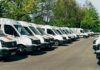 Fleet of white buses and vans, transport managers