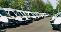 Fleet of white buses and vans, transport managers