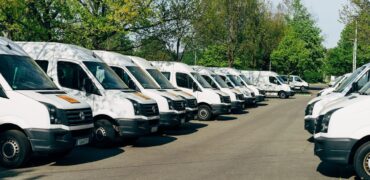 Fleet of white buses and vans, transport managers