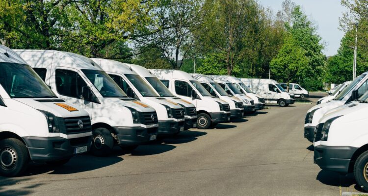 Fleet of white buses and vans, transport managers