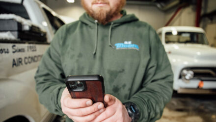 Fleet Manager using fleet management software on his phone