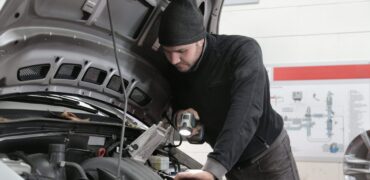 Mechanic checking vehicles