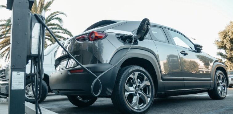 An electric car being charged, pay-per-mile