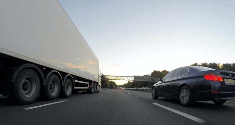 Car overtaking a lorry, road safety