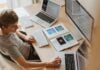 Person sitting infront of computor screens