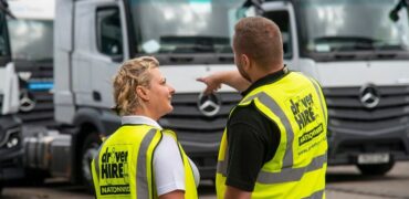 Two Driver Hire employees discussing HGVs