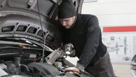 Mechanic inspecting a car engine