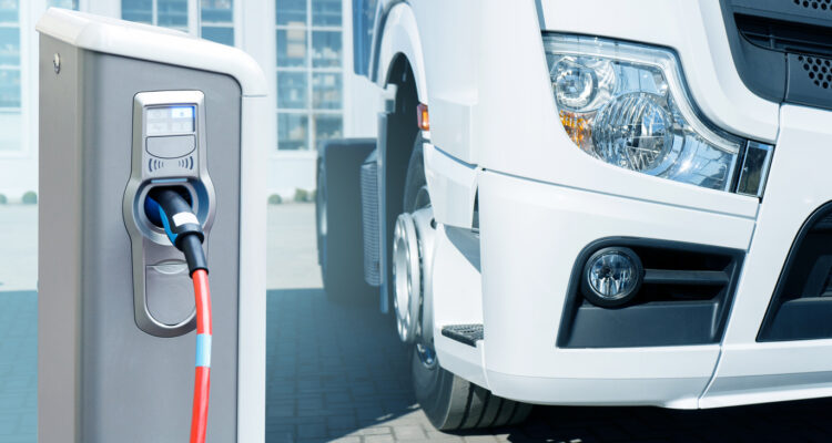 Electric vehicles charging station on a background of a truck