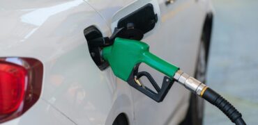 Car being fueled with green petrol pump