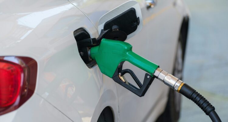 Car being fueled with green petrol pump