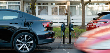 Electric car parked on the road being charges