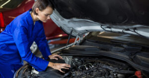 Female Mechanic servicing a car