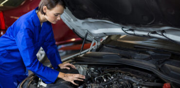 Female Mechanic servicing a car