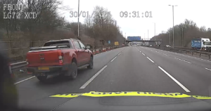 Truck jumping a rolling road block on the M6