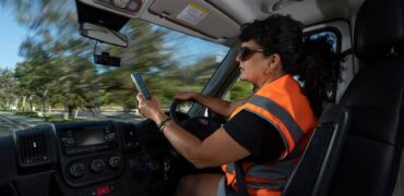 Woman driving while using a mobile phone