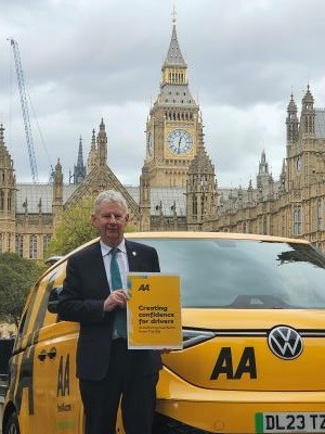 Edmund King, AA president, holding a copy of the AA Motoring Manifesto outside the Houses of Parliament.