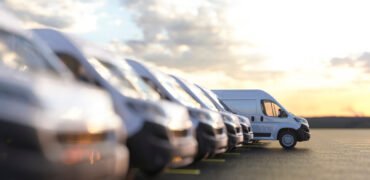 Generic row of new vans in a parking bay
