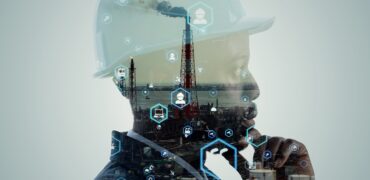 Worker wearing a hard hat superimposed on an industrial site