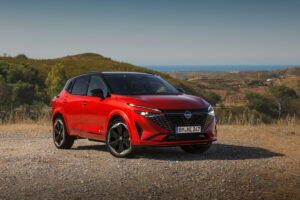 New refreshed Qashqai 2024 in fuji sunset color parked beside the road in Faro, Portugal