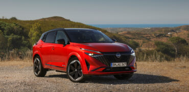 New refreshed Qashqai 2024 in fuji sunset color parked beside the road in Faro, Portugal